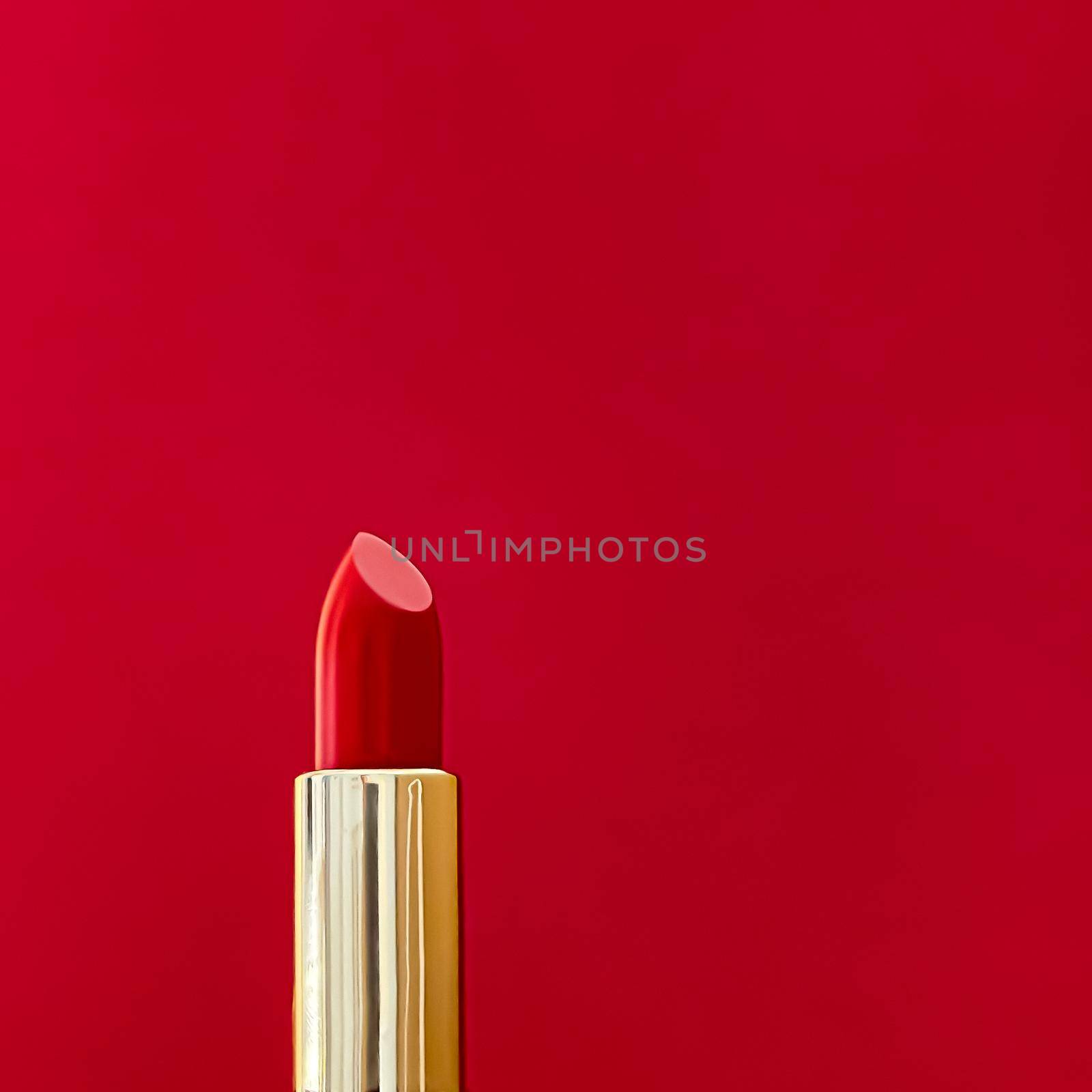 Red lipstick in golden tube on colour background, luxury make-up and cosmetics for beauty brand product design by Anneleven
