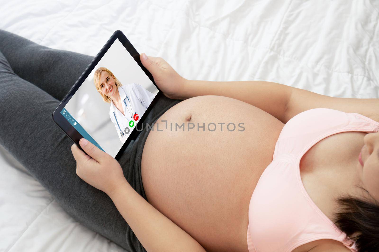Doctor telemedicine service online video with pregnant woman for prenatal care . Remote doctor healthcare consultant from home using online mobile device connect to internet for live video call .