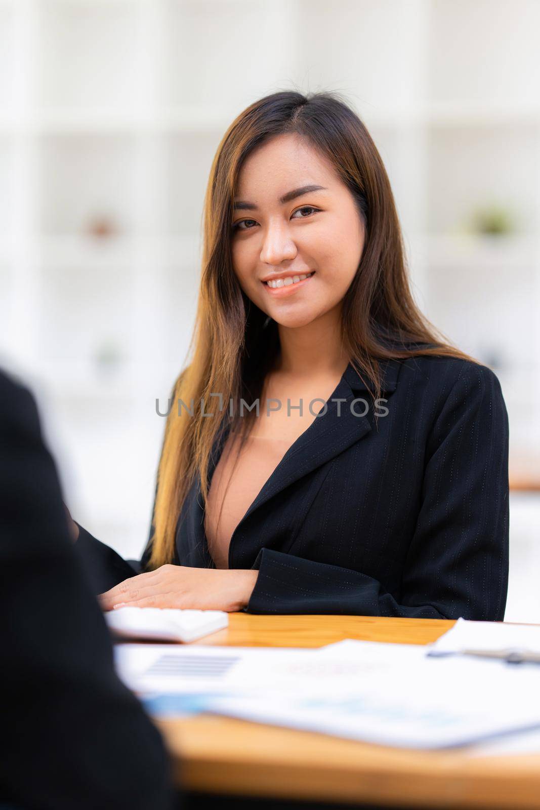 A portrait of Asian happy Businesswoman smiling and working at office