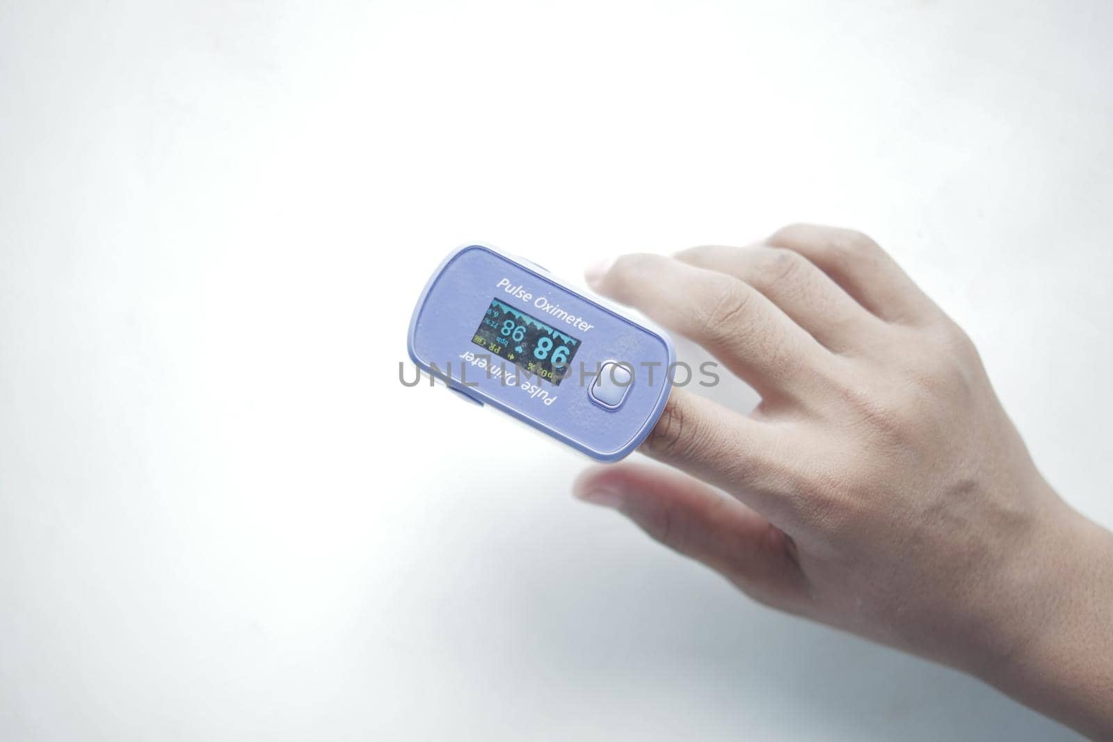 young man hand using pulse oximeter.