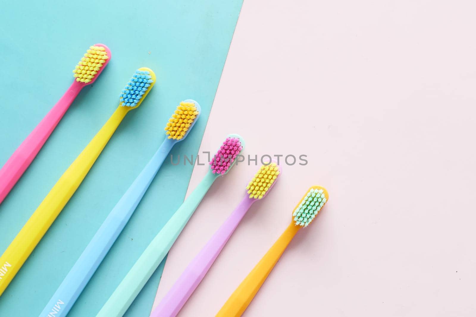 colorful toothbrushes on a color background top view ,