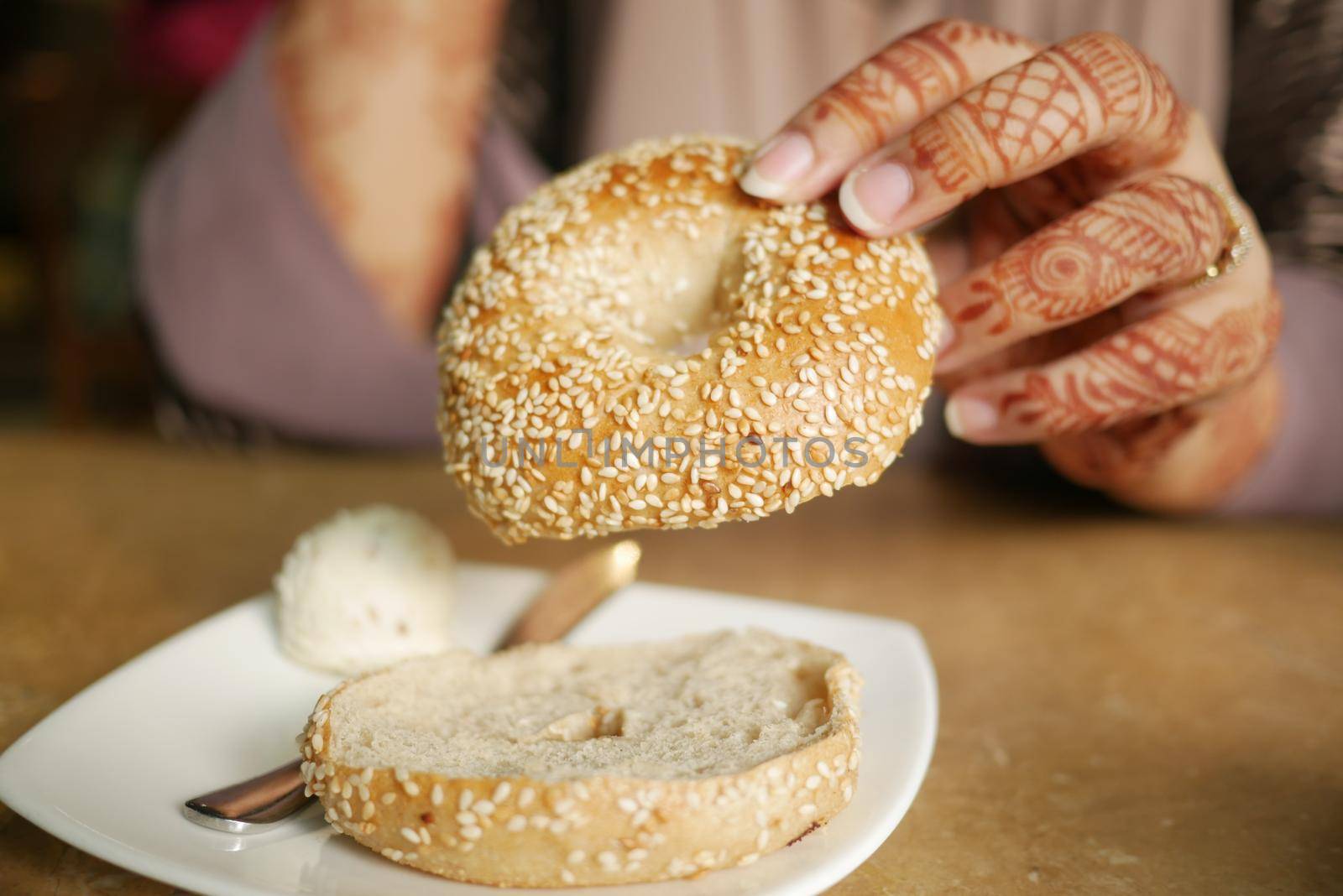 women holding a fresh bagel bread ,