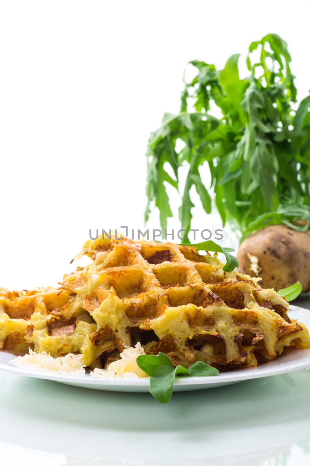 fried potato waffles with cheese in a plate isolated on white background