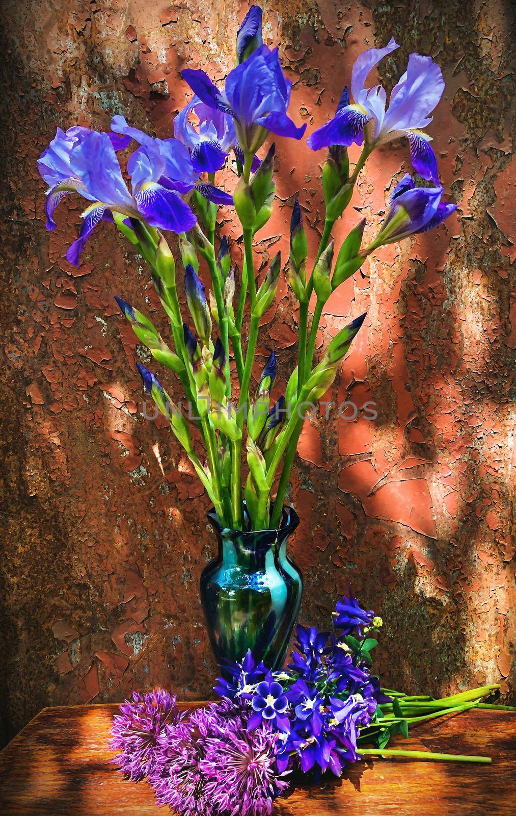 Romantic bouquets of flowers. Home decor and flowers arranging. In composition used blue irises and purple aliums