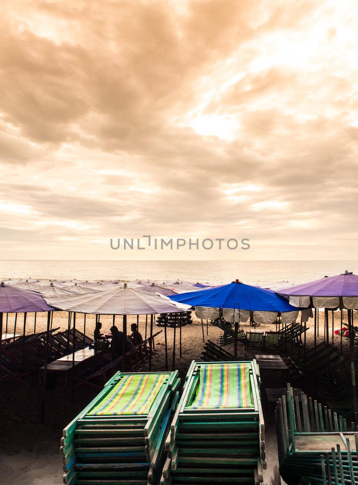 Colorful canvas daybed under the beach umbrella