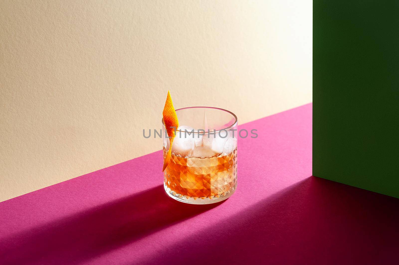 Glass with Whiskey and Ice Cube on Table with Hard Shadows. Modern Isometric Style. Creative Concept.