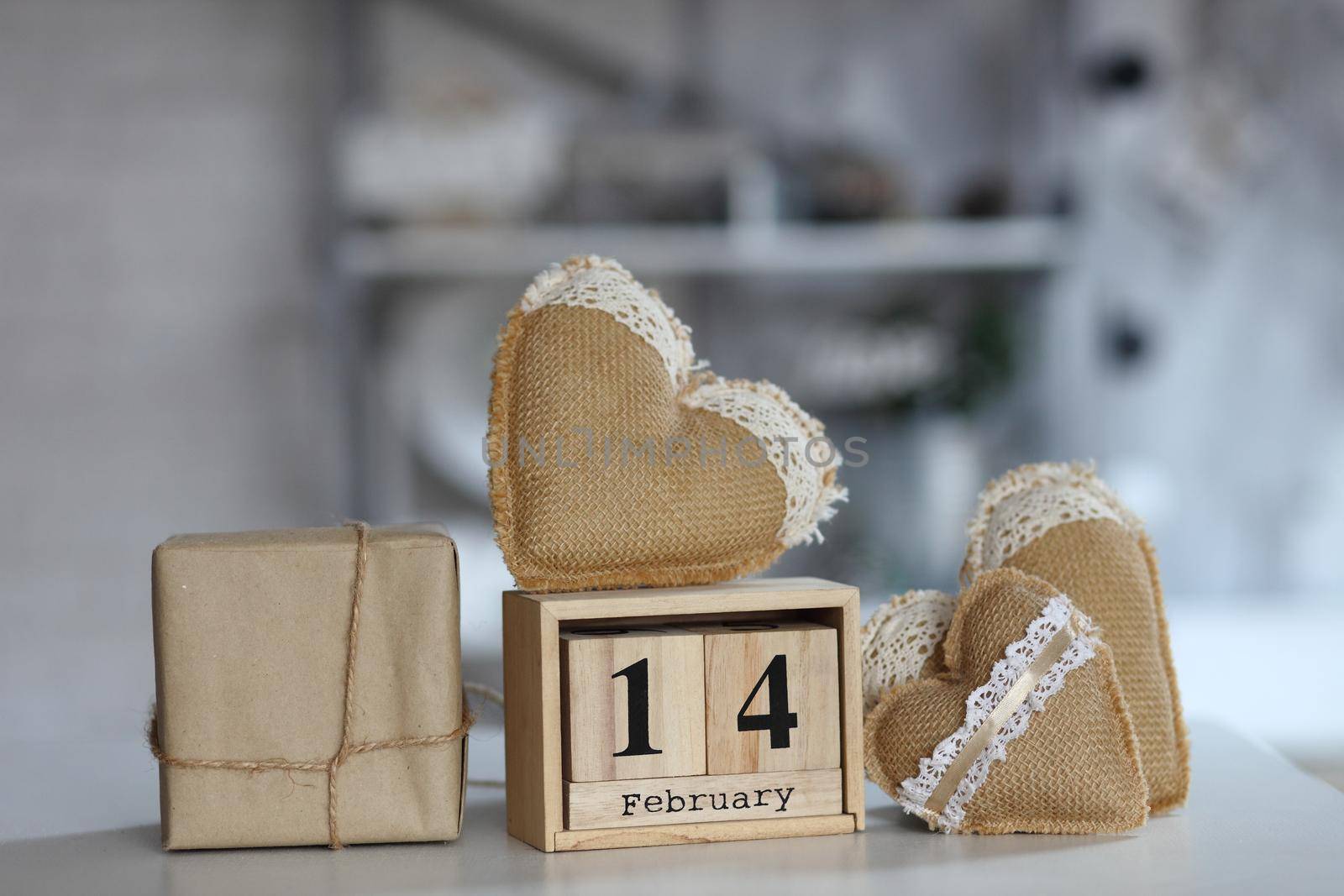 Valentines day concept. heart beside wooden block calendar set on Valentines date 14 February on table and bright room background. by IvanGalashchuk