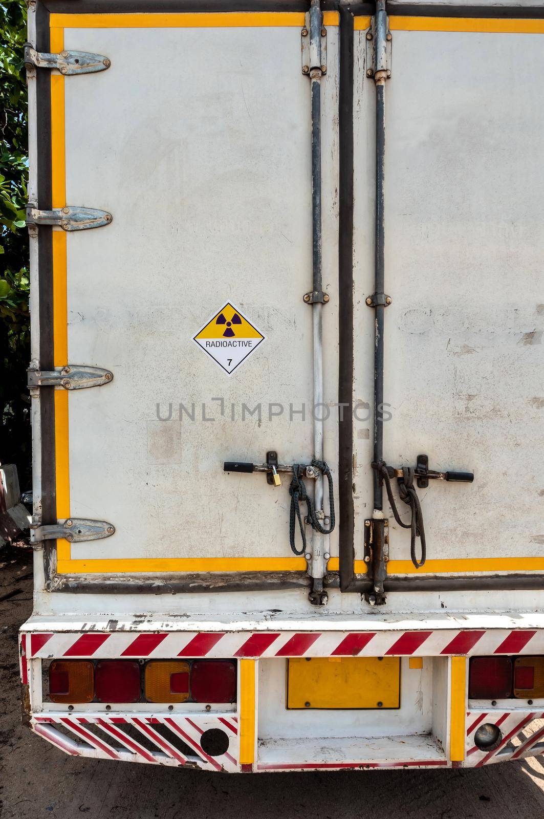 Radiation warning sign on the Hazardous materials transport label Class 7 at the aluminum container of transport truck