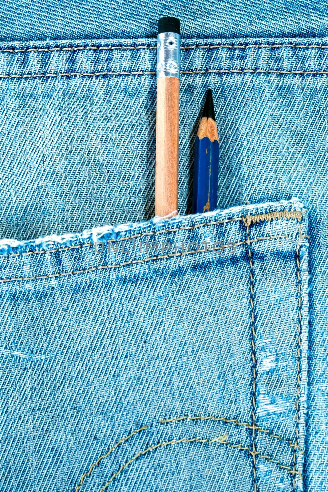 Different type of pencils in the pocket of denim blue jean