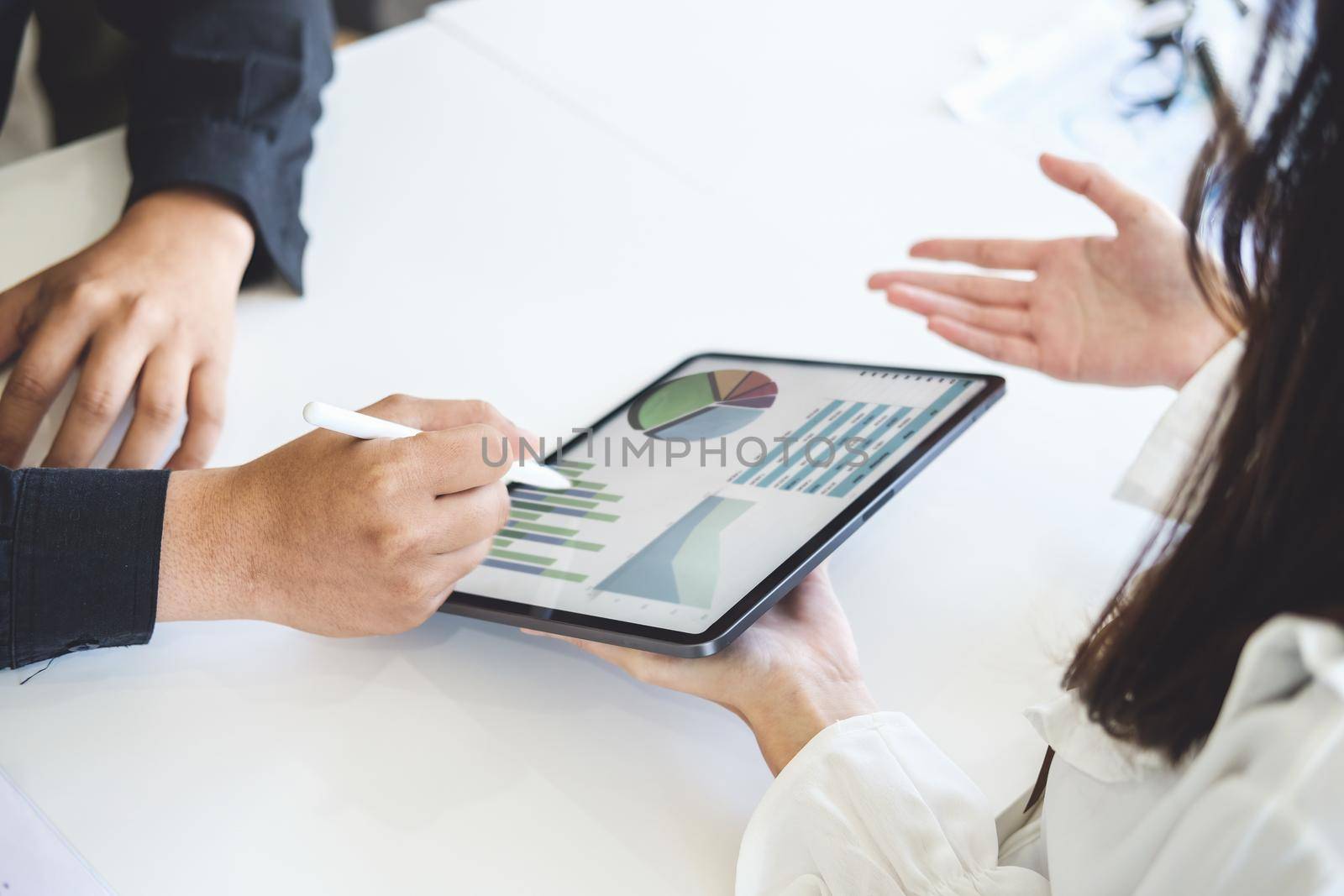 Negotiation, Analysis, Discussion,male economist and female marketer using tablet computer to plan investments and financial to prevent risks and losses for the company.