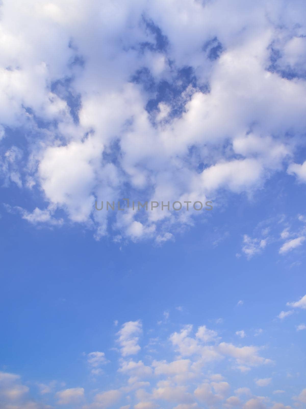 White fluffy clouds in the blue sky with morning light from the sunrise