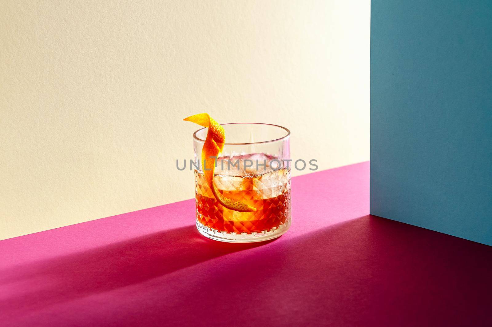 Glass with Whiskey and Ice Cube on Table with Hard Shadows. Modern Isometric Style. Creative Concept.