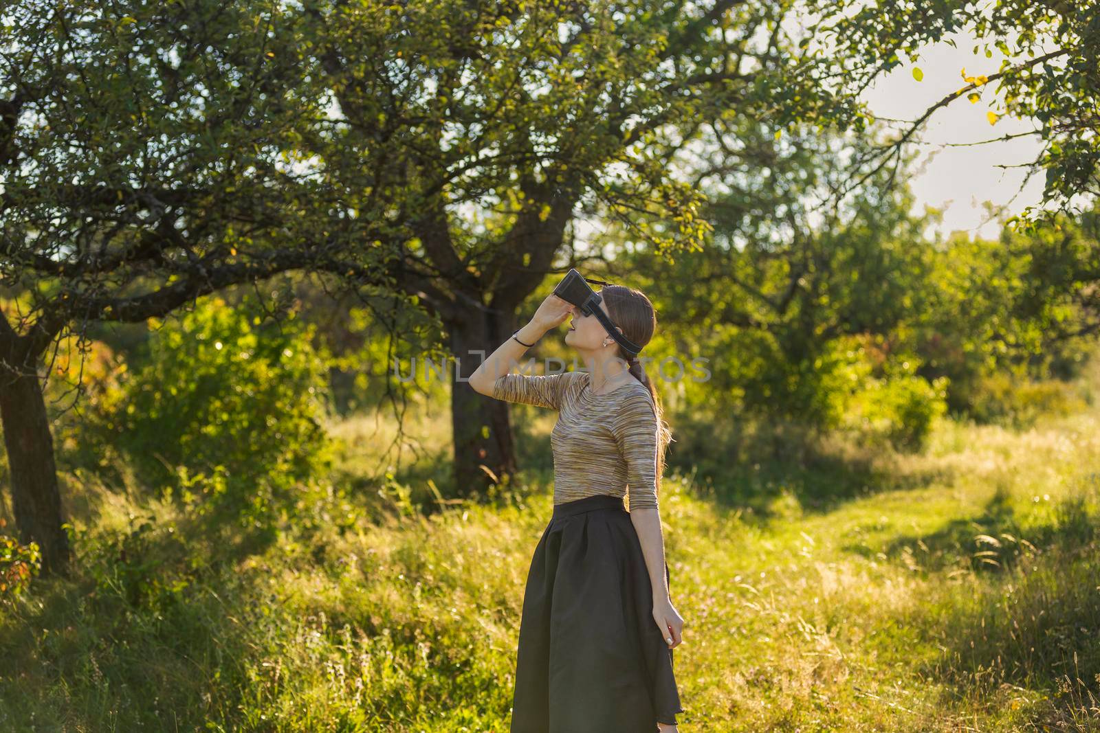 girl with virtual reality gadget in nature