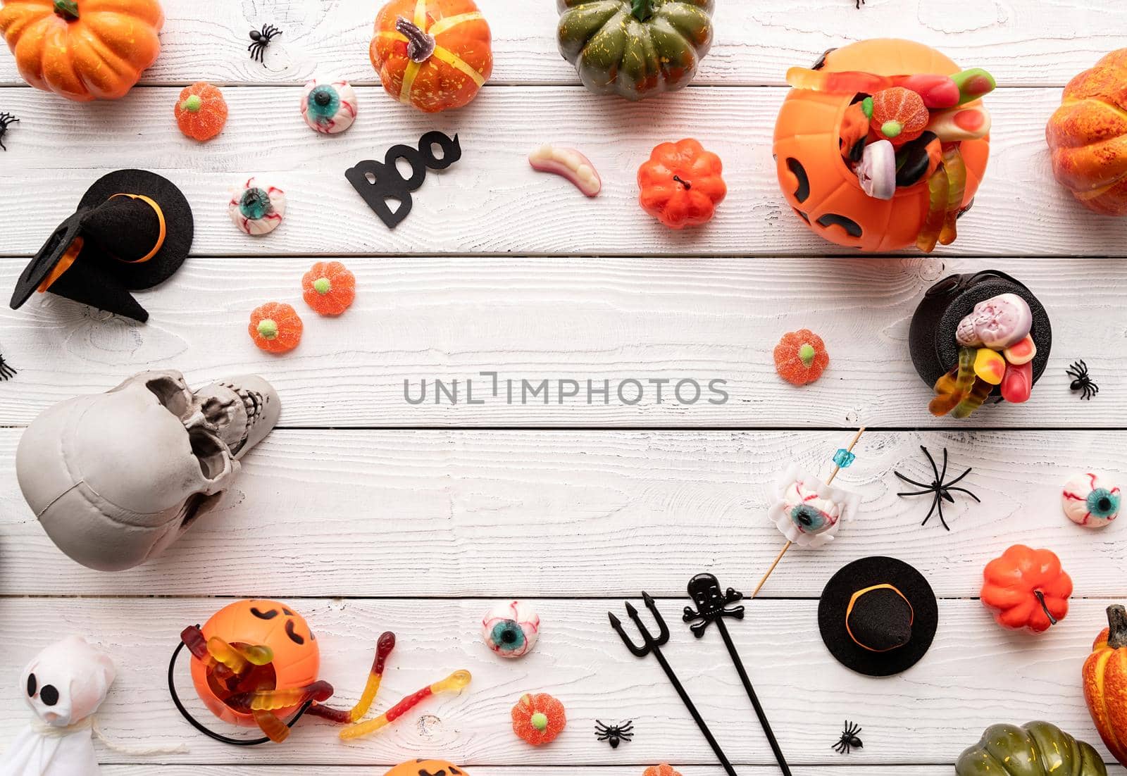 Colorful sweets for Halloween party on white wooden background, top view by Desperada