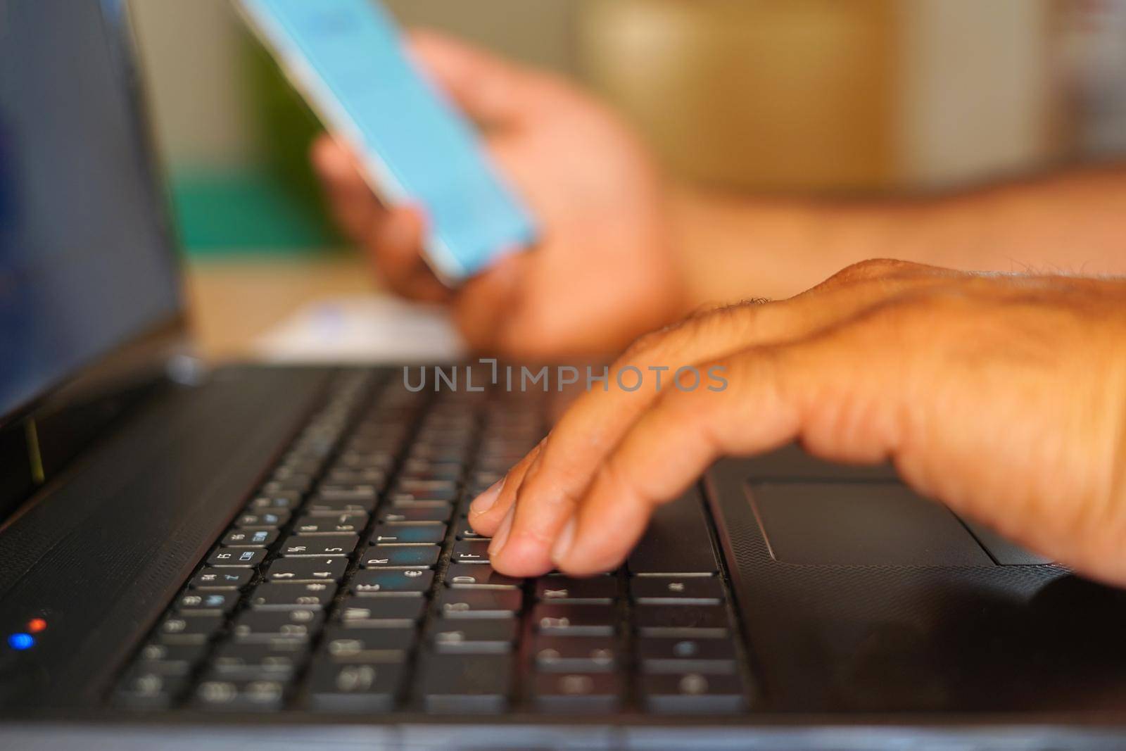 Closeup view of businessman holding modern smartphone on hands, Man working at sunny office at workplace by Mareno