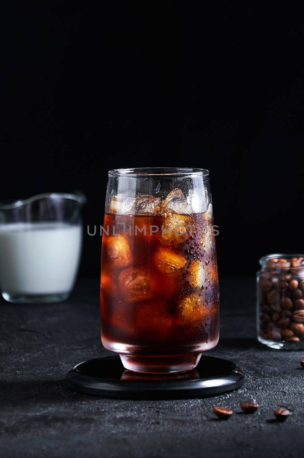 Iced Coffee in Tall Glass on Dark Background. Concept Refreshing Summer Drink by Svetlana_Belozerova