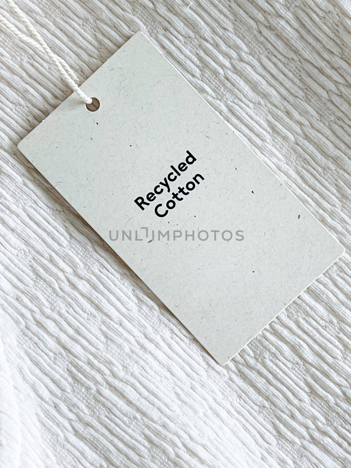 Recycled cotton fashion label tag, sale price card on luxury fabric background, shopping and retail concept