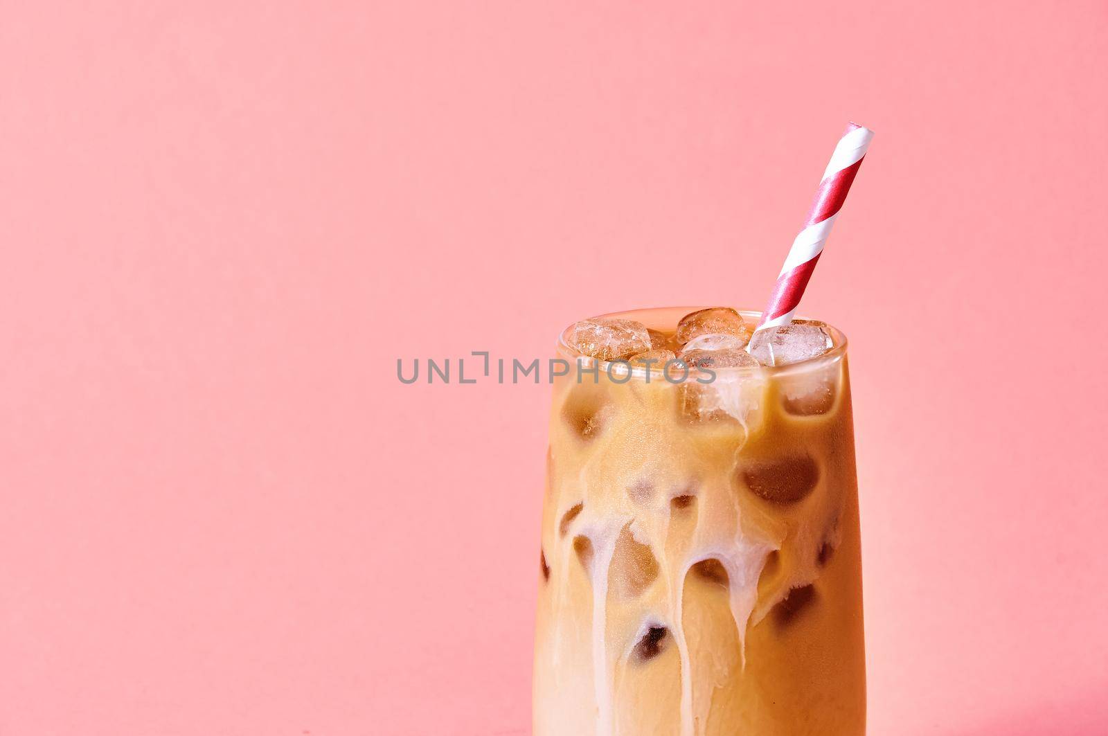 Close-up Iced Coffee with Milk in Tall Glasses on Pink Background. Concept Refreshing Summer Drink.