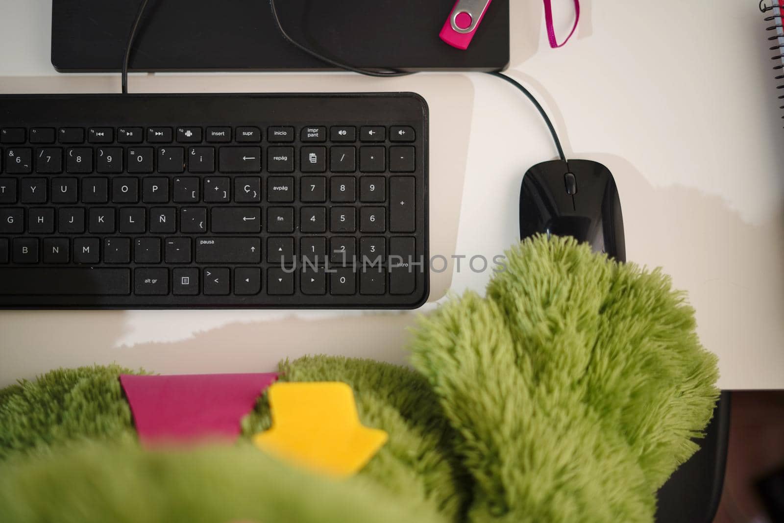 Someone is using computer keyboard and mouse next to modern black smartphone with empty screen, cup of black coffee and plant od dark wooden office desk. High quality photo