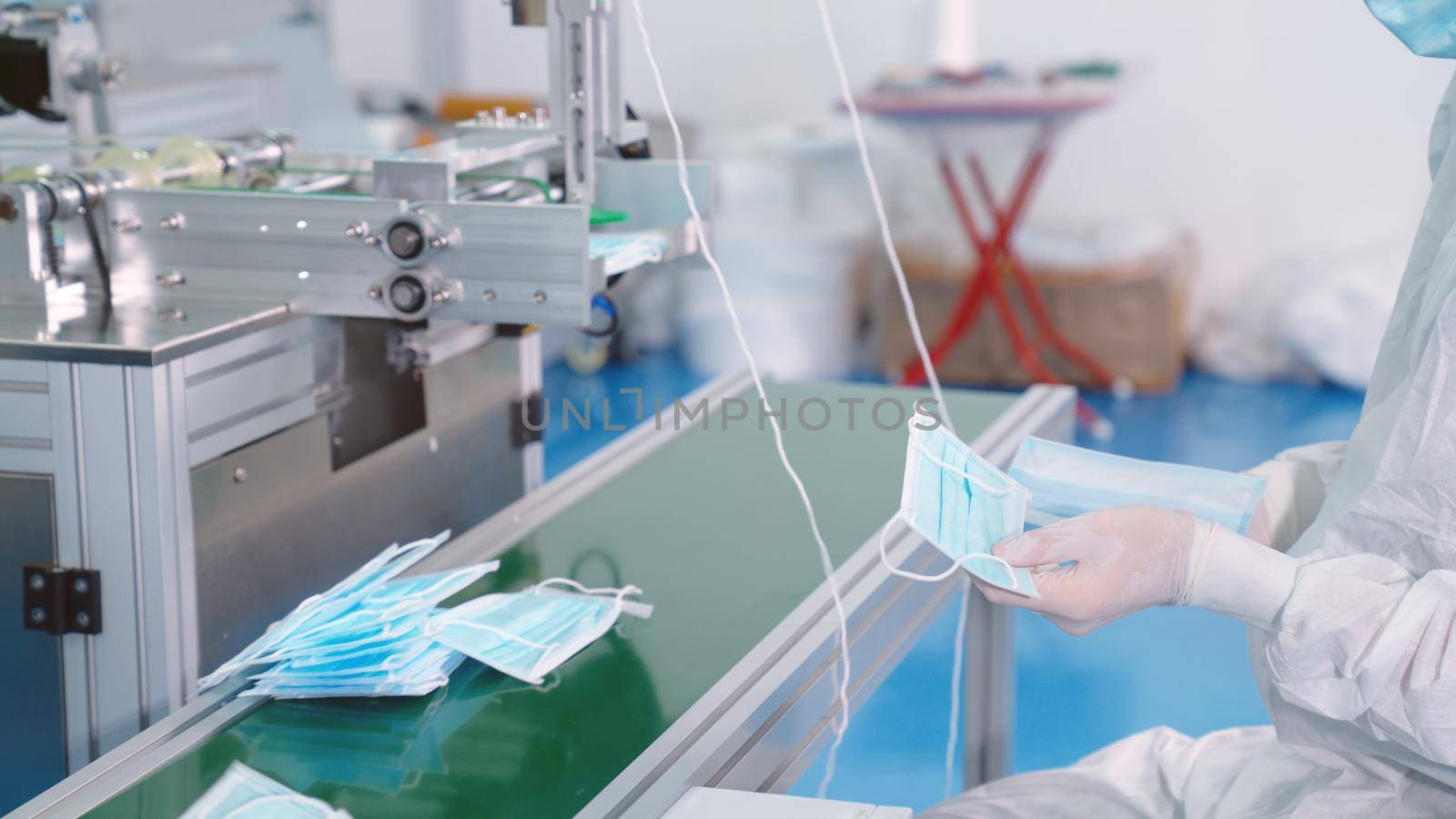 Face mask production line in modern factory by biancoblue