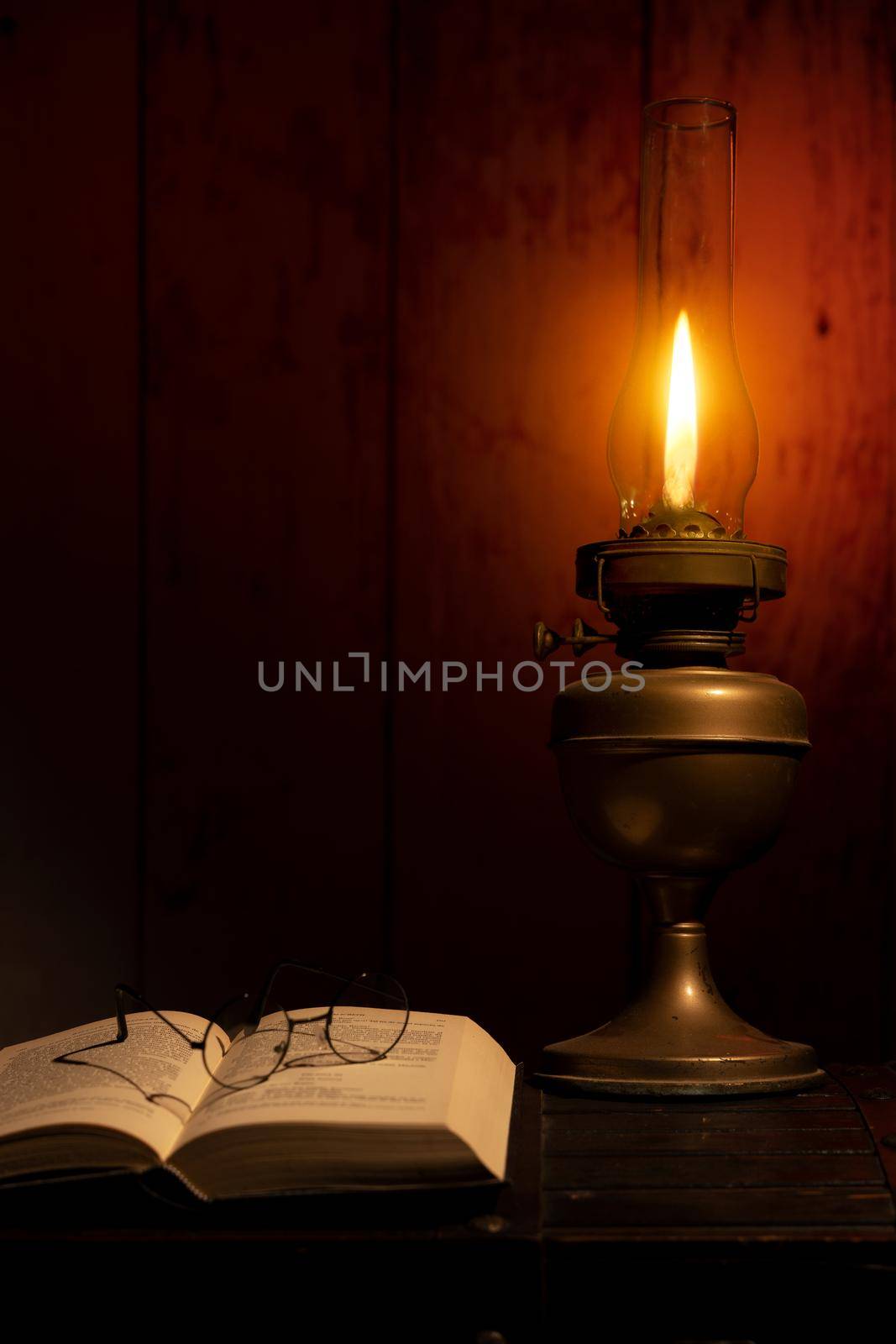 Open Bible and burning candles on table. High quality photo