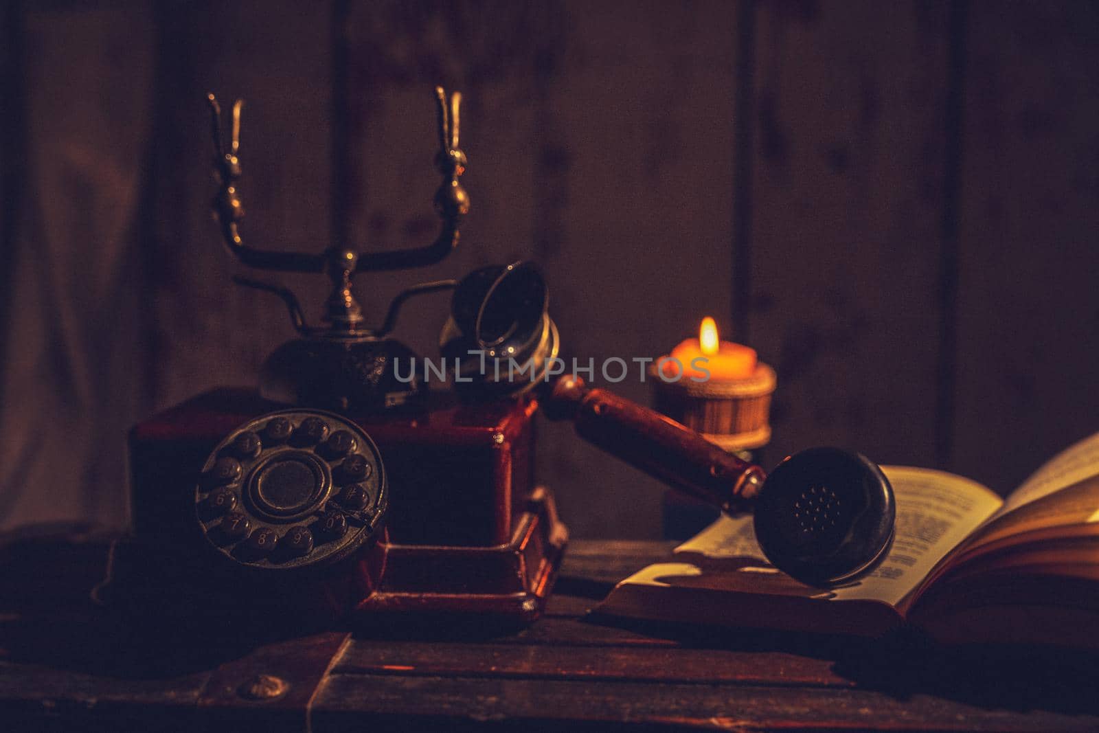 still life with old phone with book and candle by Mareno
