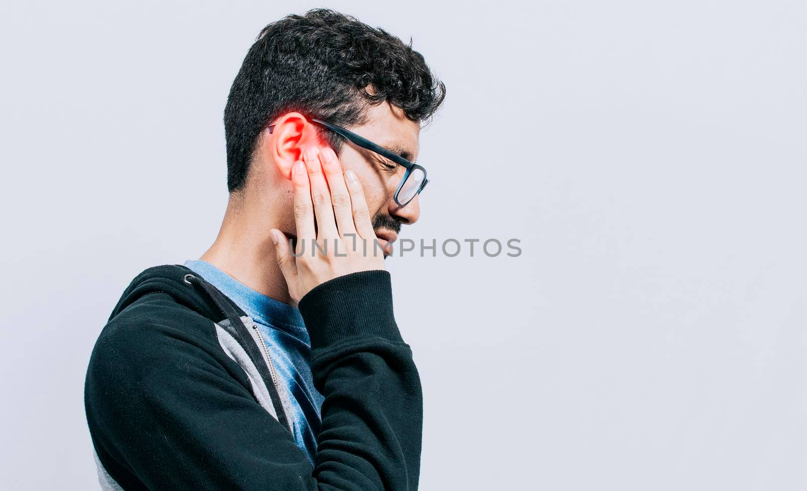 Concept of person with otitis and tinnitus, Person with ear pain, on isolated background, Suffering man massaging his ear isolated