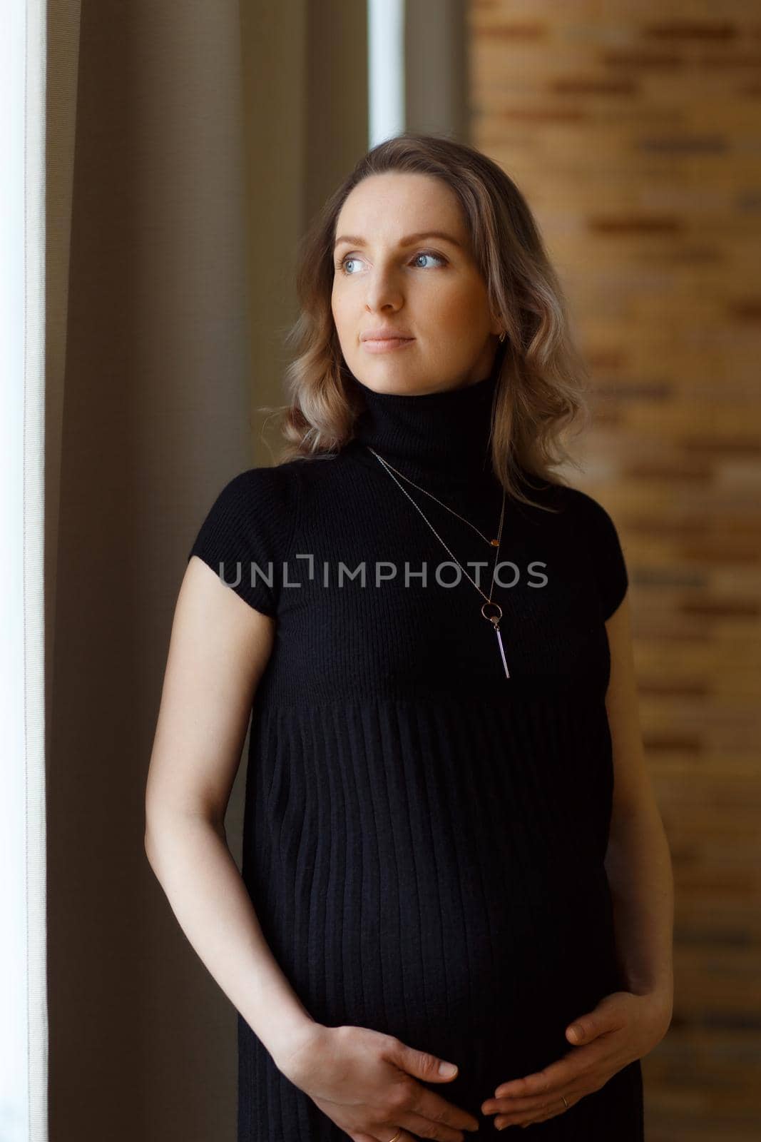 Thoughtful pregnant woman caressing her belly by BY-_-BY