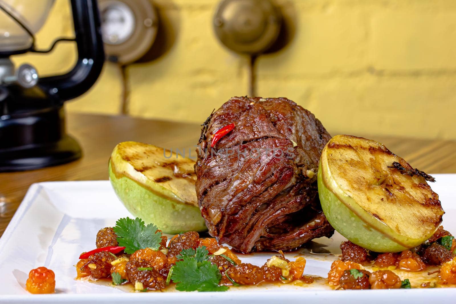 meat savory : beef fillet mignon grilled and garnished with baked apples and tomatoes by Milanchikov