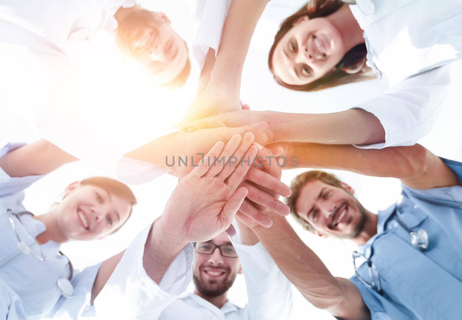 bottom view.a team of doctors at the medical center clasped their hands together.the concept of unity
