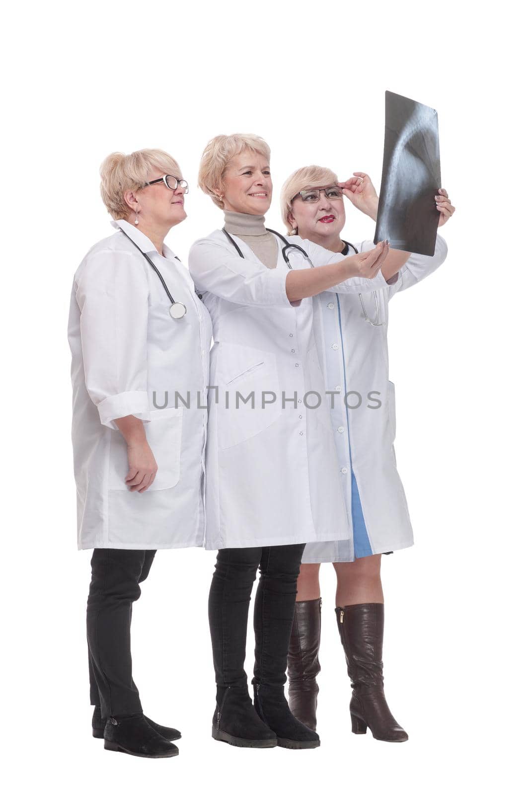 in full growth. group of qualified doctors discussing an x-ray. isolated on a white background.