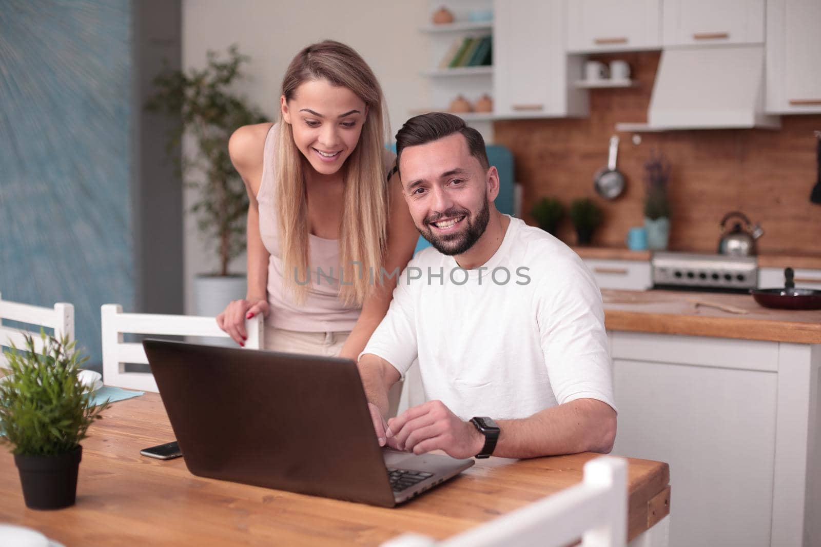 happy young couple discussing information on the Internet by asdf