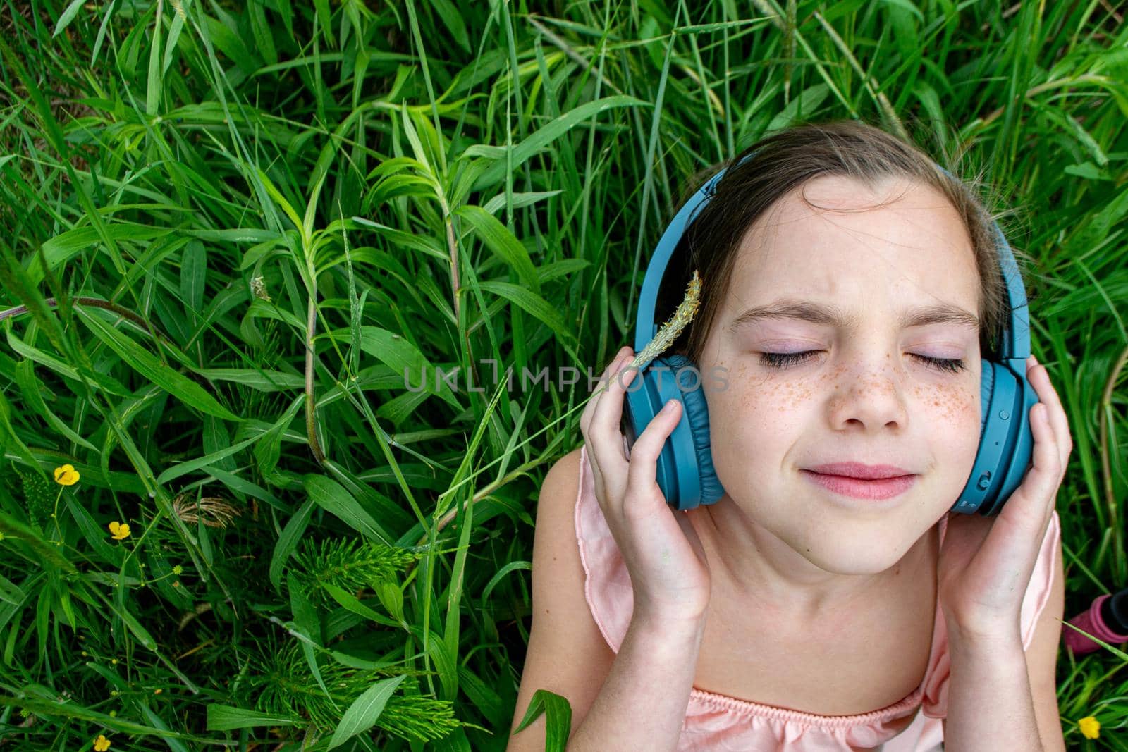 young girl listening to music on headphones. top view. The concept of lifestyle. High quality photo