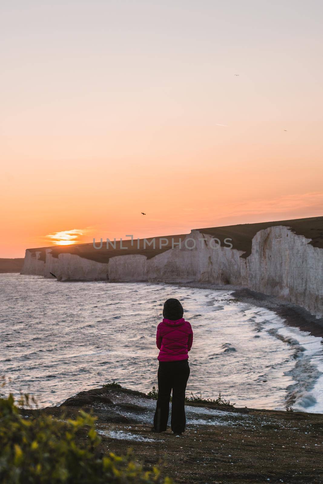 Woman watching the sunset in Seven Sisters.