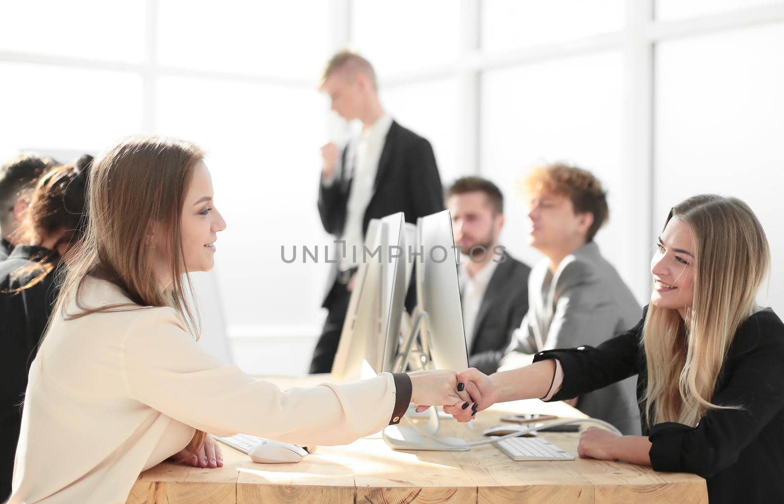 young employees shaking hands at a successful presentation . success concept