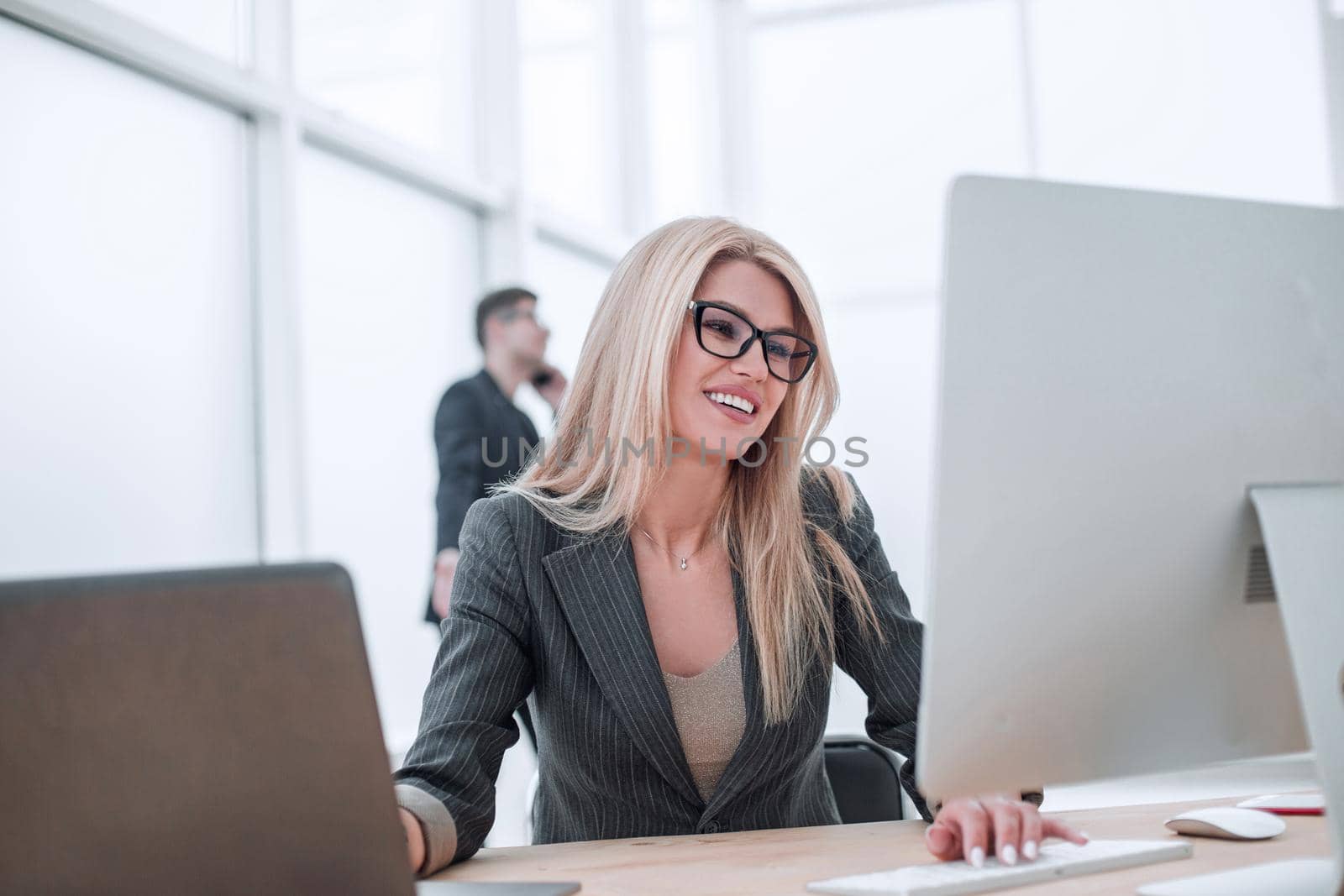 smiling businesswoman working in a modern office by asdf