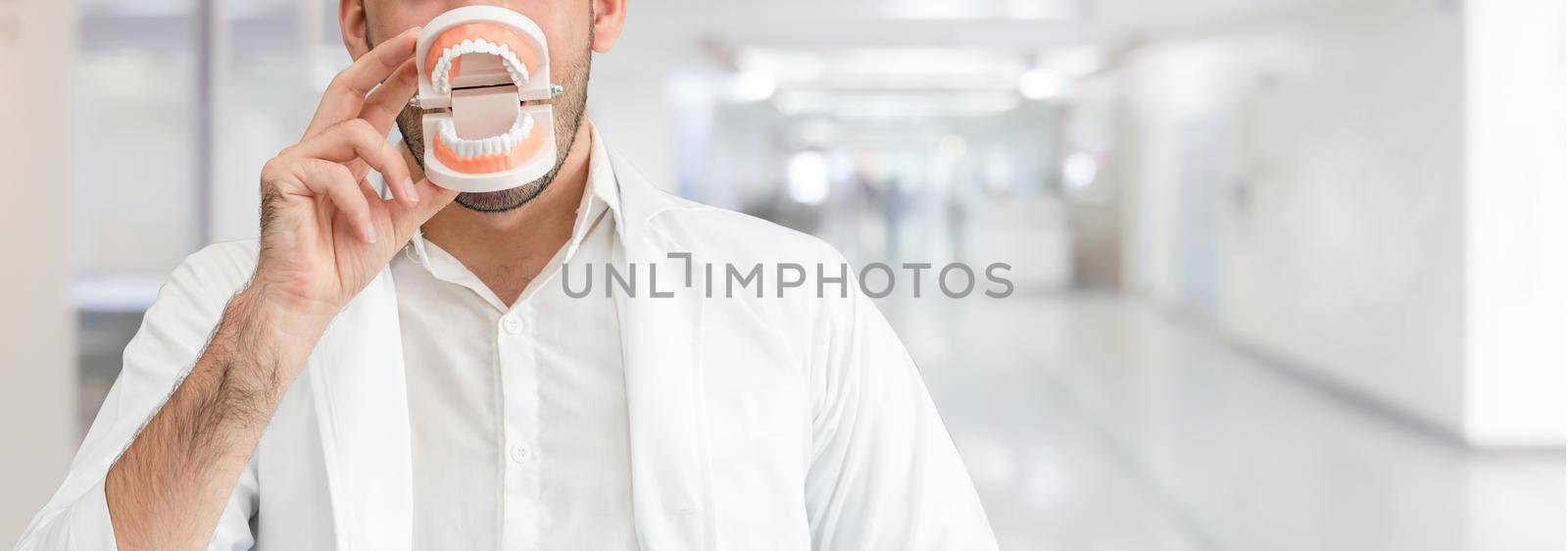 Young male dentist working in dental clinic. Dentistry care and medical service concept.
