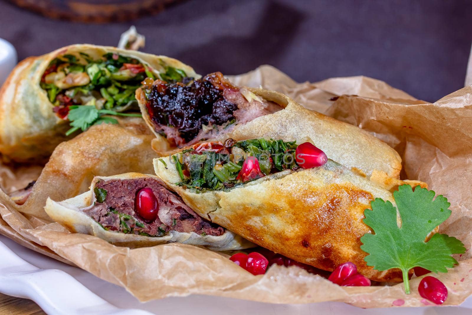 Deep fried spring rolls made it from spring roll pastry,vermicelli,carrots,cabbage,sprouts,soy sauce and peppers served with sweet chilli sauce on slate plate background.Easy vegetarian food. by Milanchikov