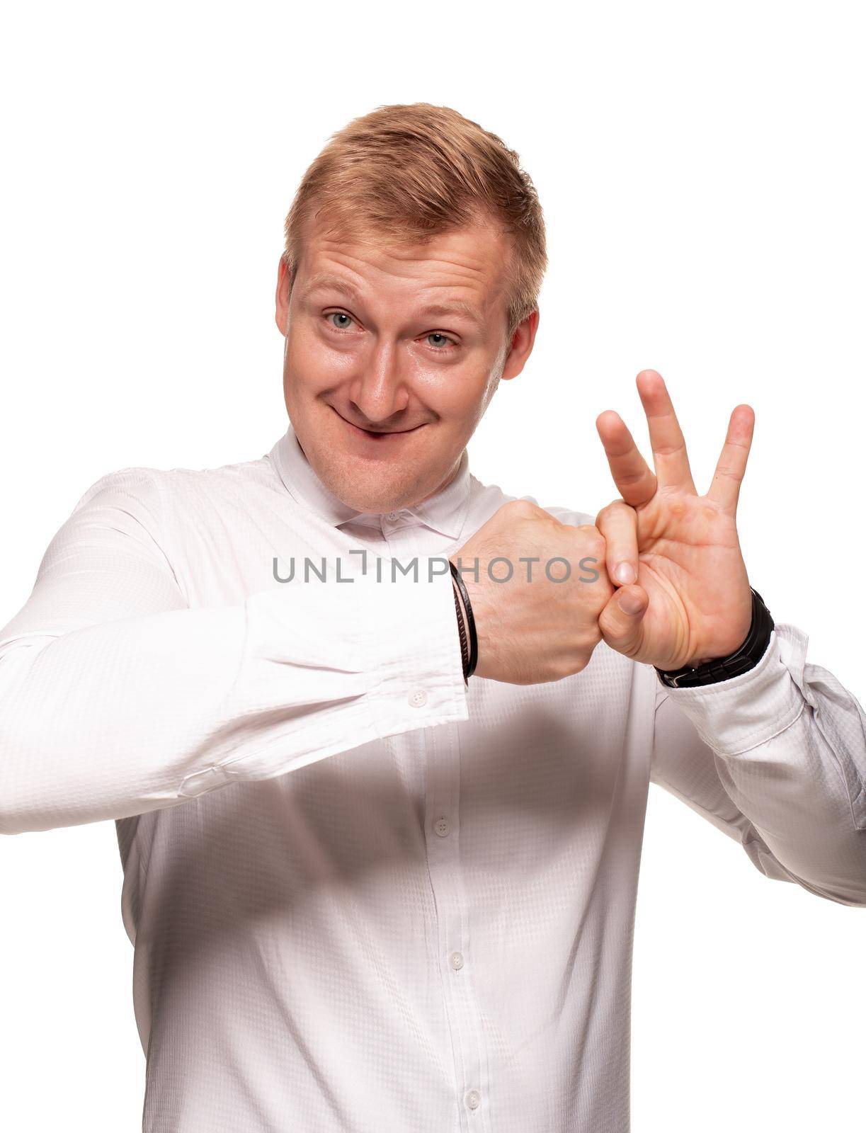 Imposing blond man in a white shirt, with black watches is gesticulating and smiling, while standing isolated on a white background