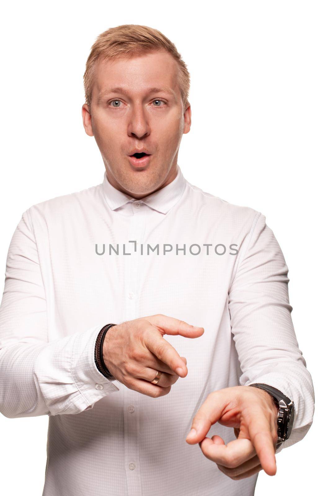 Imposing, young, blond man in a white shirt is grimacing while standing isolated on a white background by nazarovsergey