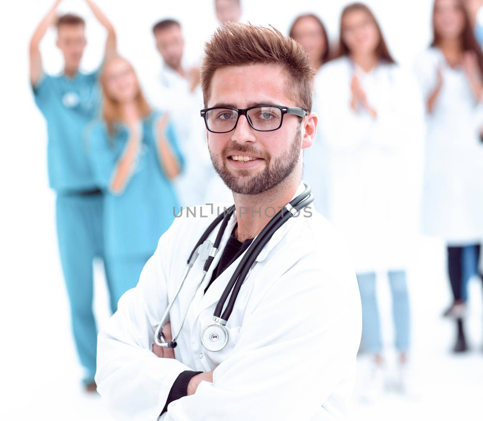 smiling chief doctor standing in front of his colleagues by asdf