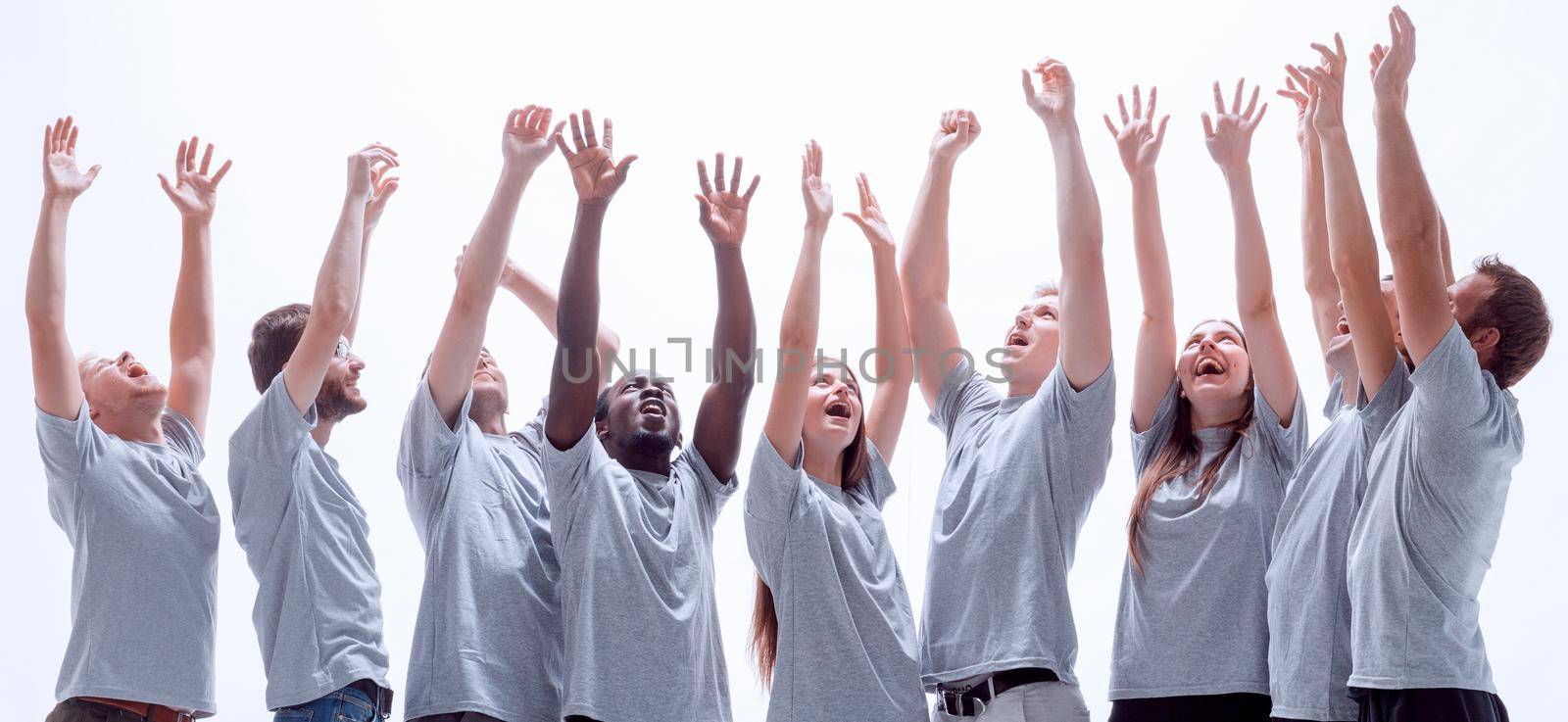 happy young people stretching their hands up. isolated on white