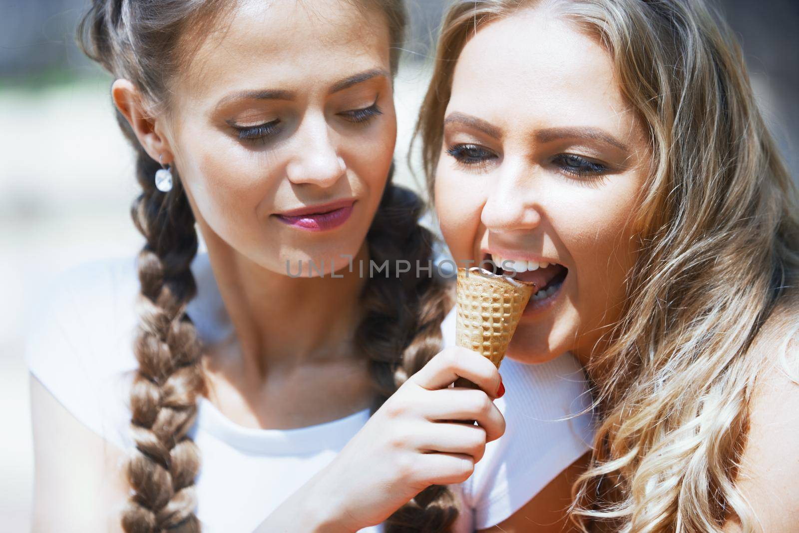 Girlfriends having fun together and eating ice cream by Novic