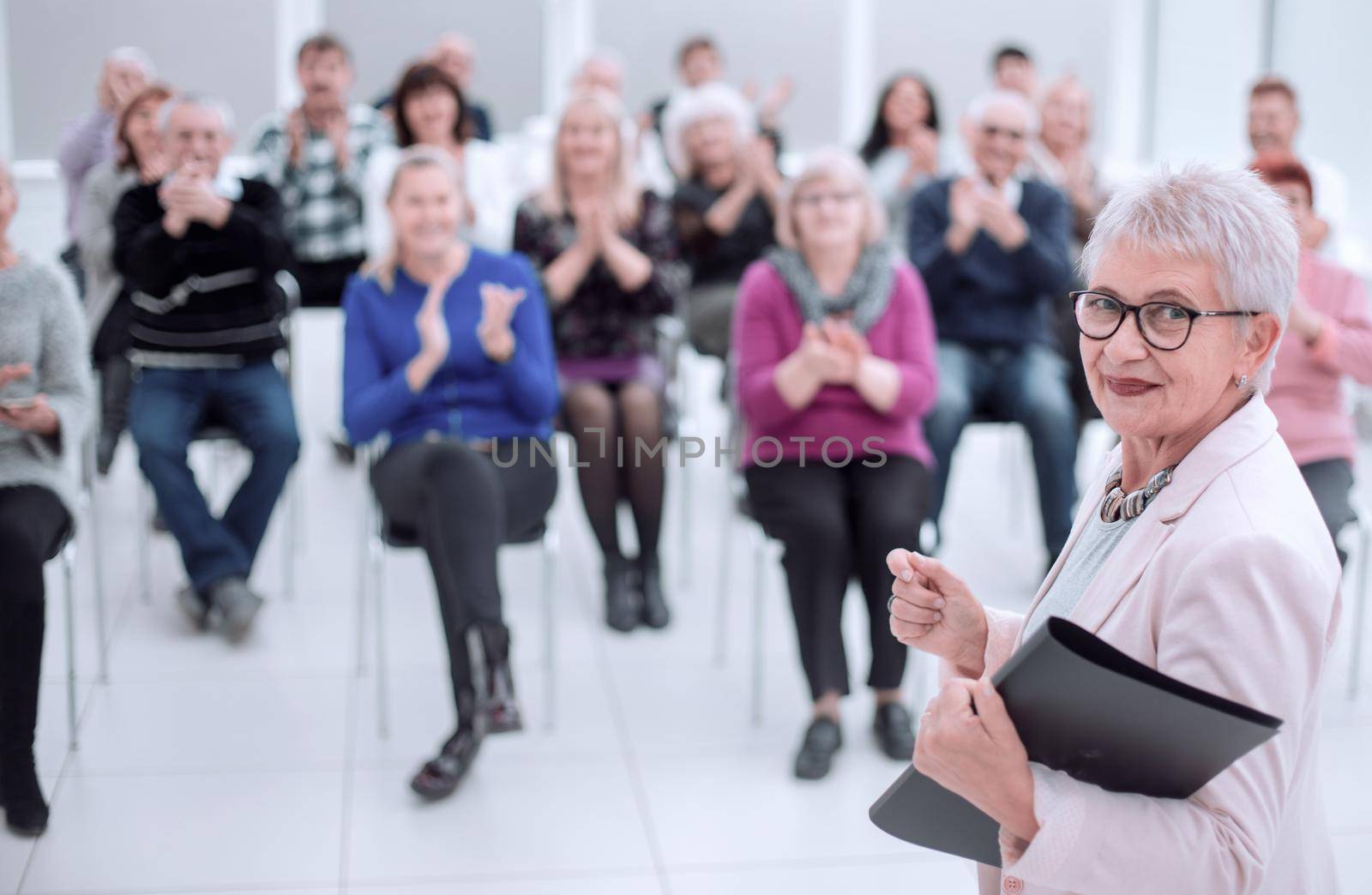 Female business executive giving a speech at a office