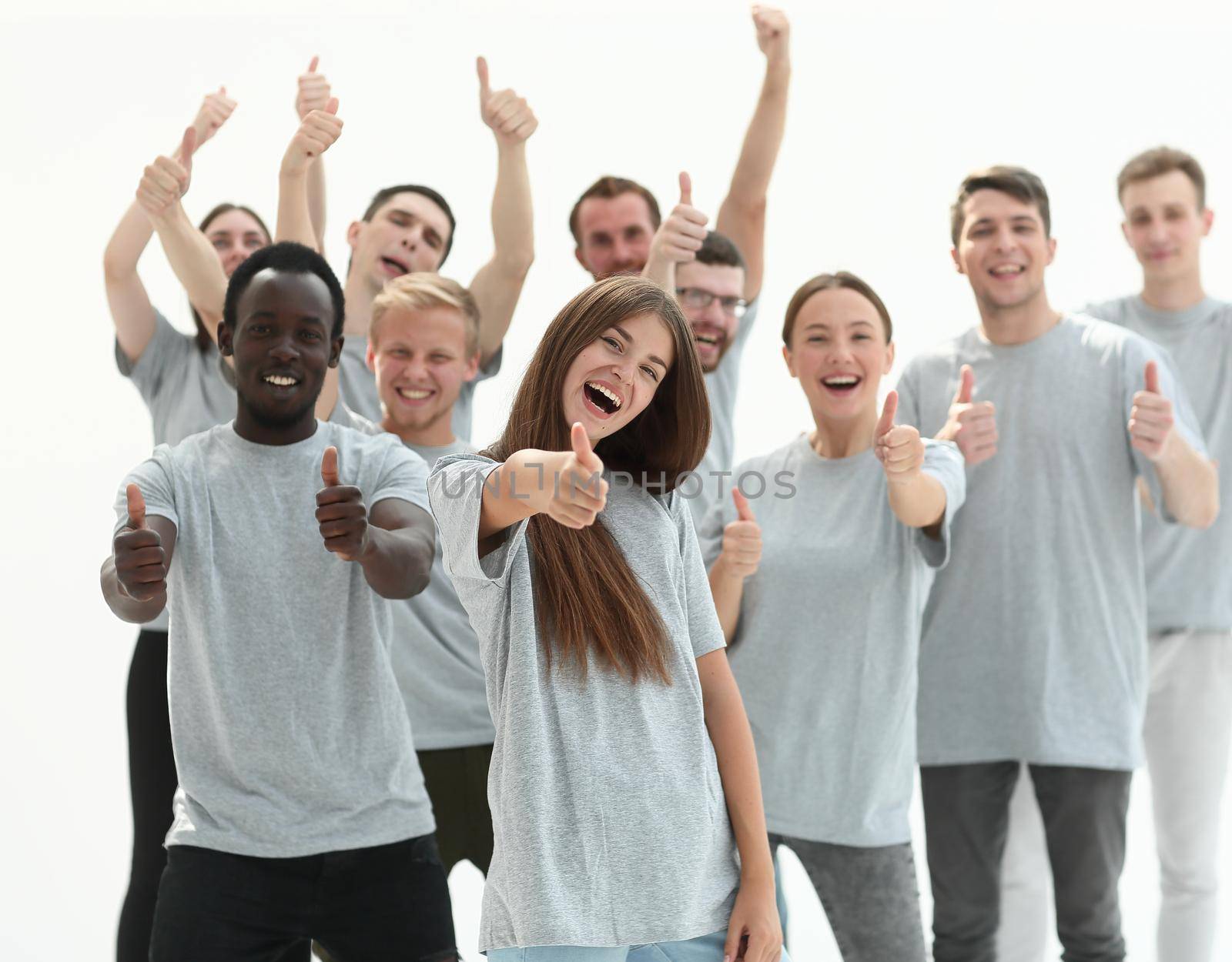 group of happy young people showing thumbs up.isolated on white