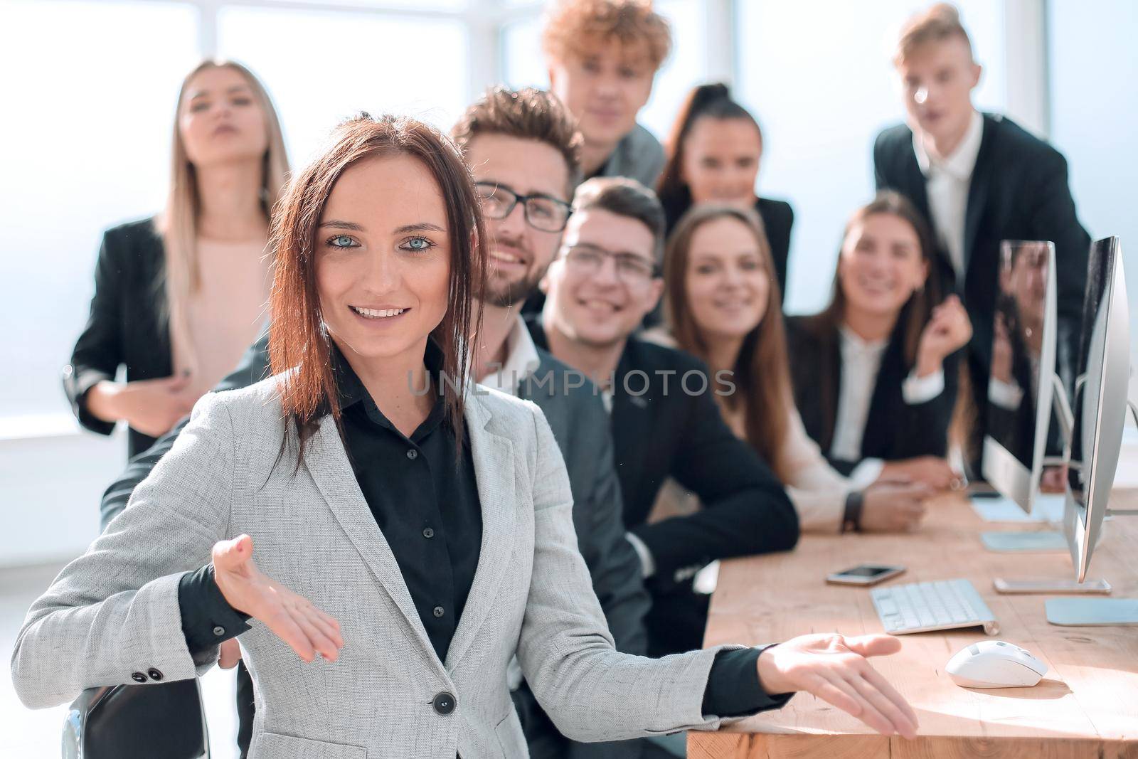 young businesswoman sitting in front of her business team. by asdf