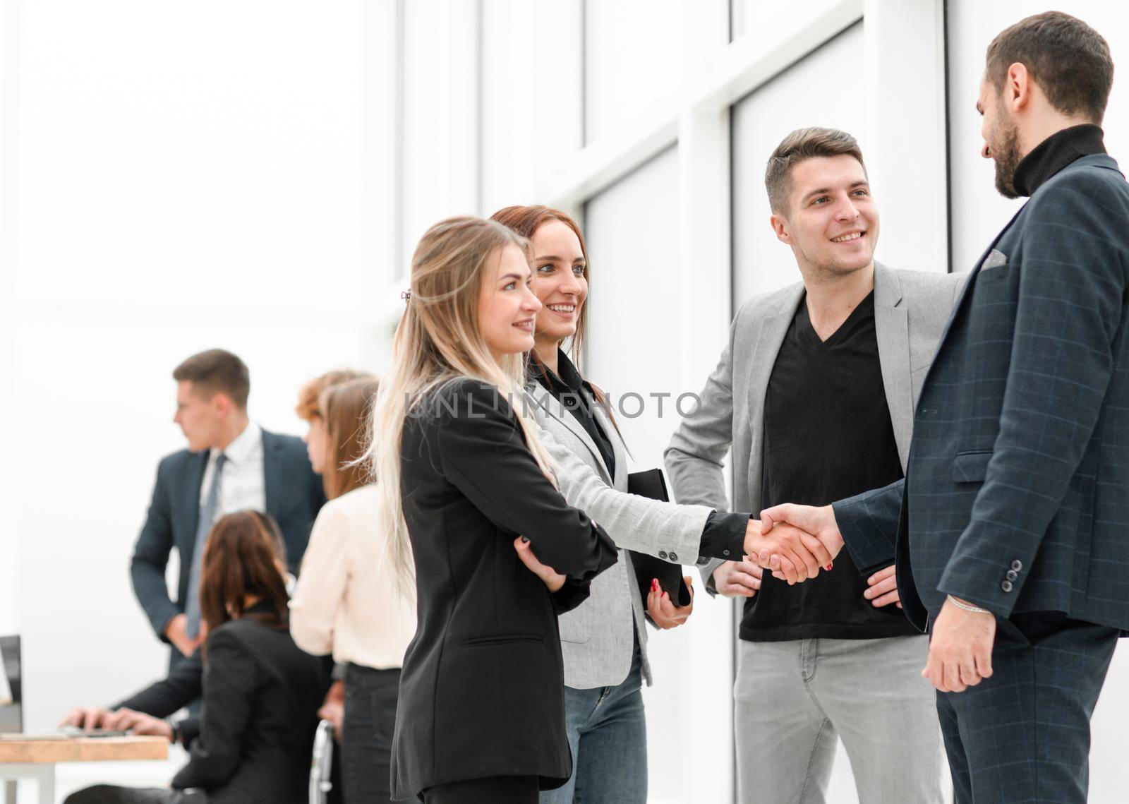 business colleagues greeting each other with a handshake by asdf