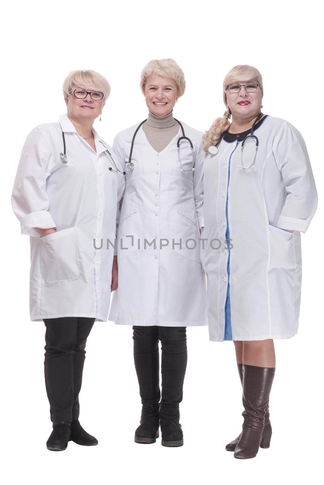 in full growth. group of qualified doctors standing together. isolated on a white background.