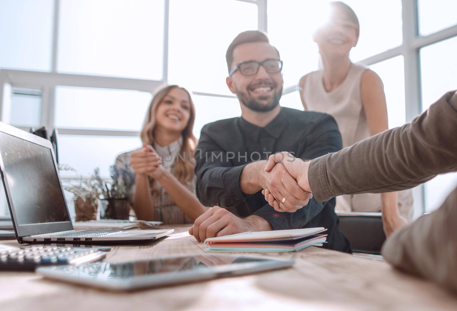 welcome handshake of business partners in the office. photo with space for text