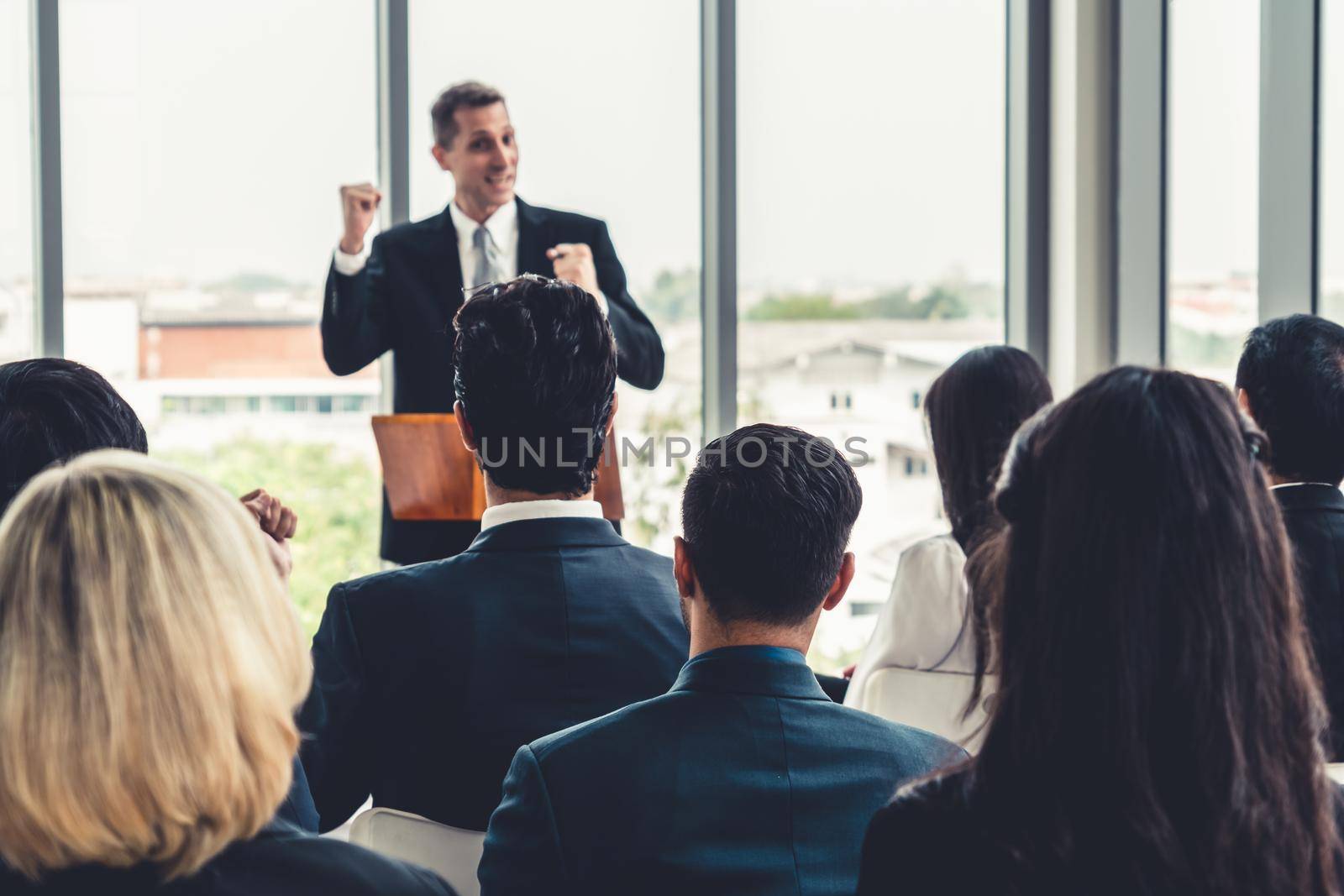 Group of business people meeting in a seminar conference by biancoblue